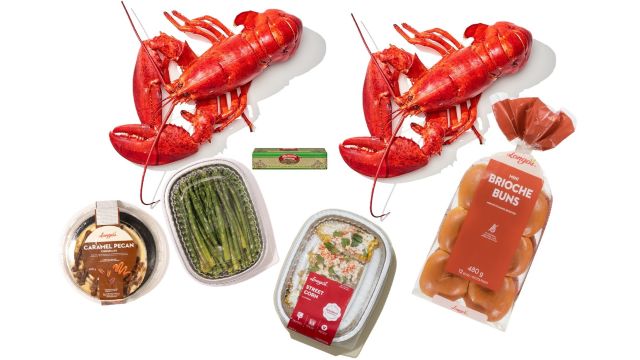 Prepared lobster dinner kit with two whole lobsters, asparagus, sauces, and sides, ideal for catering and celebration meals.